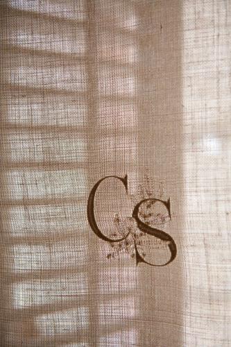 a letter s written on a window curtain at Casa Rural Sullà in Tremp