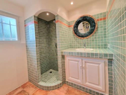 a bathroom with a shower with a sink and a mirror at Villa Pio in Roquebrune-sur-Argens