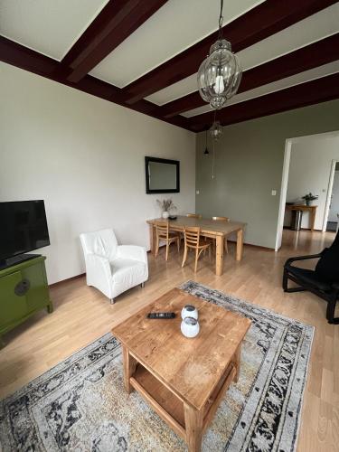 a living room with a coffee table and a couch at Vakantiehuisjes Marsherne in Poppingawier