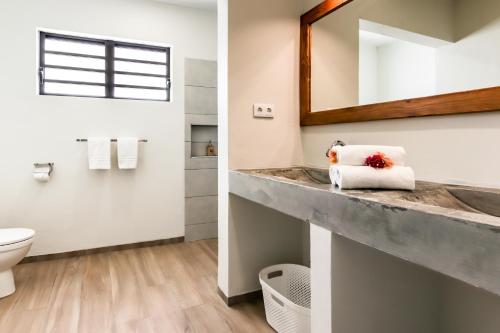 a bathroom with a sink and a mirror at ABC Resort Curacao in Willemstad