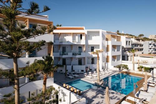 an aerial view of a building with a swimming pool at Petradi Beach Lounge Hotel in Rethymno