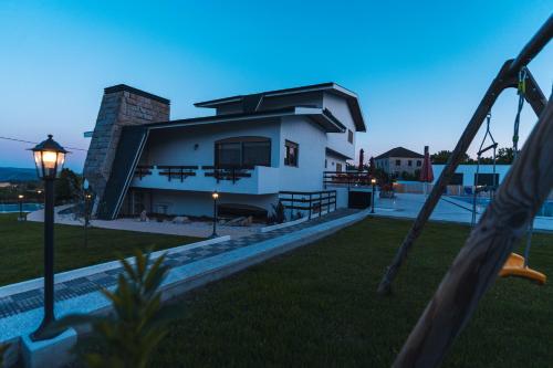 a view of a house from a swing at Quinta da Costinha in Alijó
