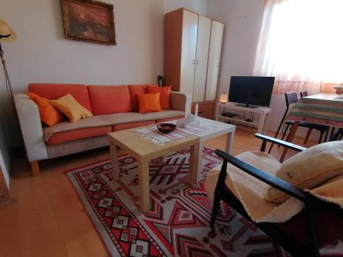 a living room with a couch and a table at Villa Lila in Dolno Dupeni