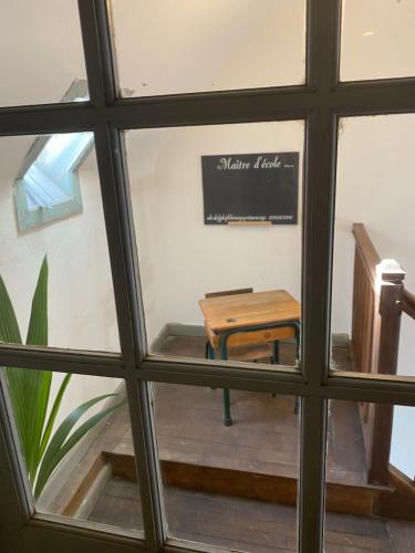 a view of a table from a window at Demeure de kergoguen in Plougonver