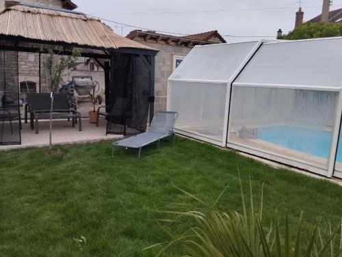 a white tent in a yard with a swimming pool at Gitedelatournelleauxerre in Auxerre