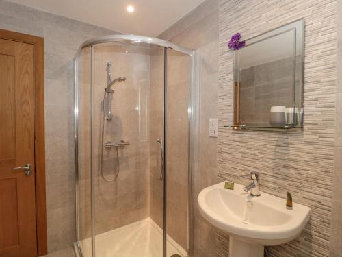 a bathroom with a shower and a sink at The Winning Post in Bruton