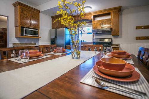 a kitchen with a table with plates and bowls on it at Cottage in the City - Historic Charm, Modern Touch in Saint Paul