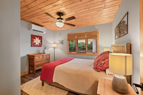 a bedroom with a bed and a ceiling fan at Wildcat Chalet in Seven Devils