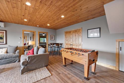 a living room with a game table and a couch at Wildcat Chalet in Seven Devils