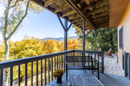 a porch with a bench and a view of the mountains at Wildcat Chalet in Seven Devils