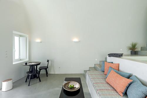 a living room with a couch and a table at Thera Villas in Fira