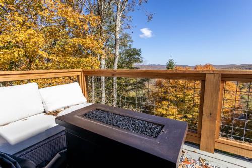 a balcony with a bed and a view of trees at Wildcat Chalet in Seven Devils