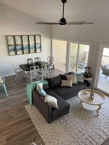 a living room with a couch and a table at Lake Travis Oasis next to Pool, Marina, Boat ramp in Leander
