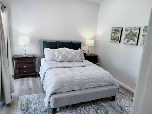 a bedroom with a bed and two night stands and two lamps at Lake Travis Oasis next to Pool, Marina, Boat ramp in Leander