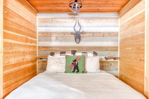 a bedroom with a bed with a wooden wall at Wy'east Nest in Government Camp
