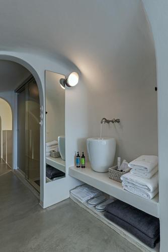 a bathroom with a sink and a mirror at Thera Villas in Fira