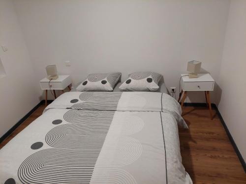 a bedroom with a large bed with two night stands at bel appart T2 confortable en plein coeur de Sigean in Sigean