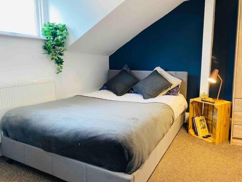 1 dormitorio con 1 cama con pared azul en Beautiful 2 bedroom apartment - close to beach, en Waterloo