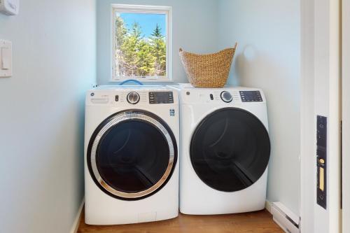 two washing machines in a room with a window at Tree House at Harts Neck in Saint George