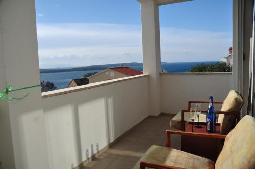 a room with a balcony with a view of the ocean at Guest House Stefica in Hvar