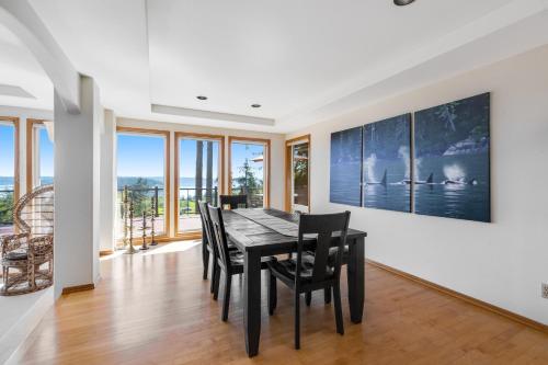 a dining room with a black table and chairs at Hubbard Hill Haven in La Conner