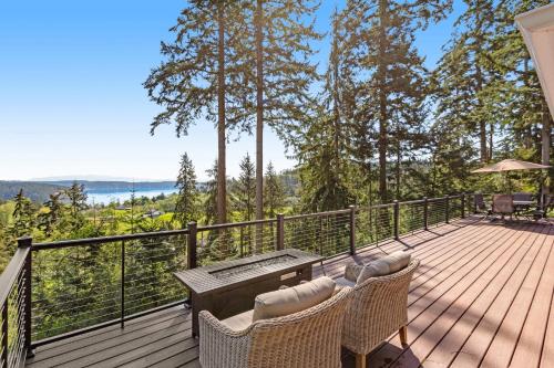 a deck with two chairs and a table on it at Hubbard Hill Haven in La Conner