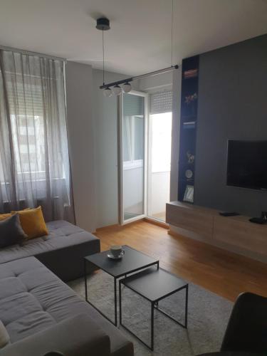 a living room with a couch and a table at Sajam 1 in Novi Sad