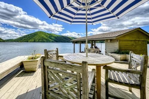 a wooden deck with a table and an umbrella at Our Point of View in Huddleston