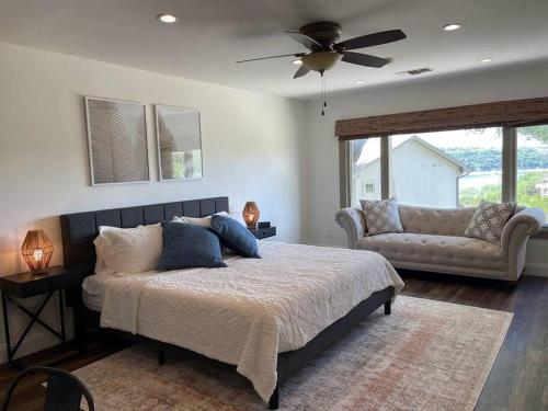 a bedroom with a large bed and a couch at Lakeview Bungalow-Access to Lake, Pool, Gym, &Park in Lago Vista