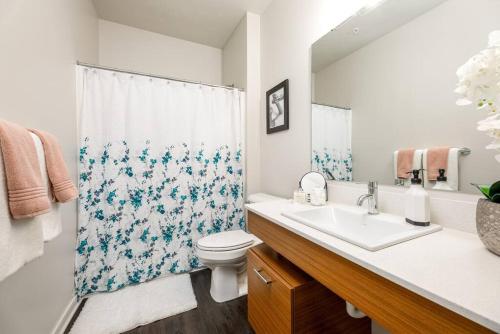 a bathroom with a sink and a toilet and a shower at Fun & trendy condo close to downtown and the beach in Traverse City