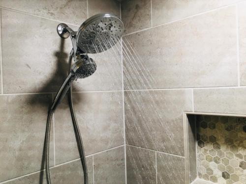 a shower with a shower head in a bathroom at Priceless Black Hills View in Rapid City