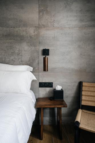 a bedroom with a bed and a table with a lamp at Auberge du Lyonnais in Annecy