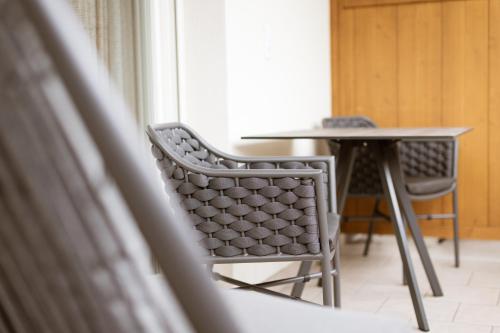 a table and a chair in a room with a table at Residence Walchhof in Schenna