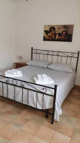 a bedroom with a bed with two towels on it at la casetta in Montefiascone