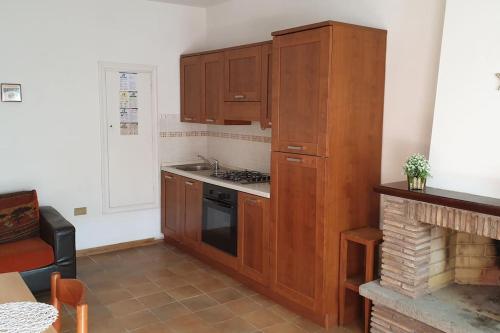 a kitchen with wooden cabinets and a stove at la casetta in Montefiascone