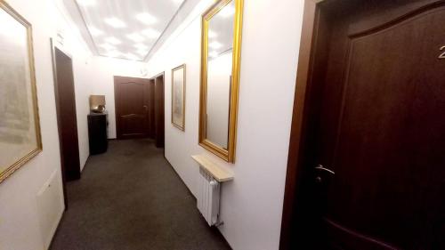 a corridor of a hallway with a door and a mirror at Hotel i Restauracja 13 Smaków in Częstochowa