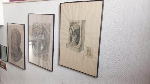 a group of framed drawings on a wall at Hotel i Restauracja 13 Smaków in Częstochowa