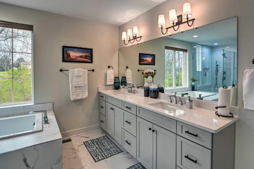 a bathroom with two sinks and a large mirror at Beautiful Nashville Home near Downtown with Hot Tub! in Nashville