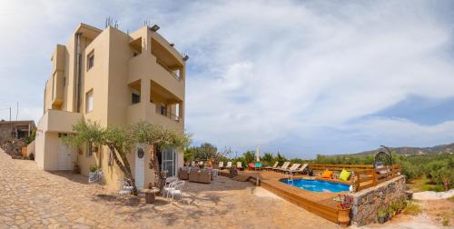 a building with a swimming pool next to a house at Princess Sissi, Villa-House with private pool and garden in Sissi