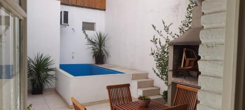 a balcony with two chairs and a blue tub at LA CASITA in Buenos Aires