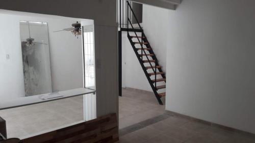 a room with a staircase and a stair case at LA CASITA in Buenos Aires