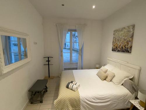 a bedroom with a white bed and a window at Maison avec vue sur le Château in Orléans