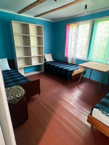 a room with two beds and a couch and windows at База відпочинку Енергія in Rudnya Peskovskaya