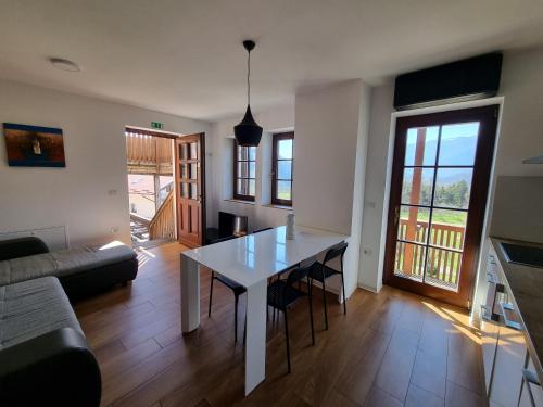 a living room with a table and a couch at Apartments Pri Jakobu in Kobarid