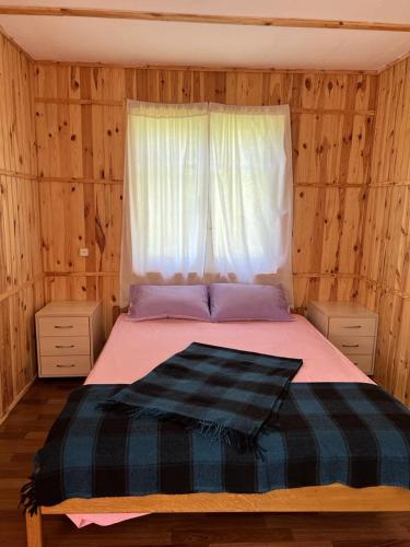 a bedroom with a large bed with a window at База відпочинку Енергія in Rudnya Peskovskaya