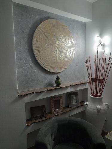 a room with a mirror and a chair and a vase at Luxury b&b Le Rocce in Villasmundo