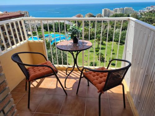 a balcony with a table and two chairs at ÁGUiLA WONDERFUL AT HOME in Benalmádena