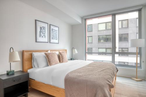 a bedroom with a bed and a large window at NoMa 1br w wd concierge gym nr Metro WDC-647 in Washington, D.C.