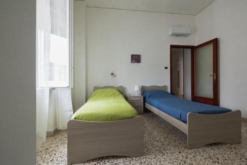 a bedroom with two beds and a window at I Giardini di Manu’ in Salerno