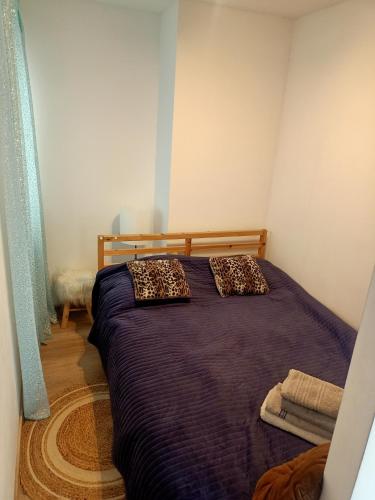 a bedroom with a bed with leopard pillows on it at Przytulne studio - 2 pokoje,parking,blisko centrum-6km,tramwaj, Nflix, park, spokój, in Wrocław
